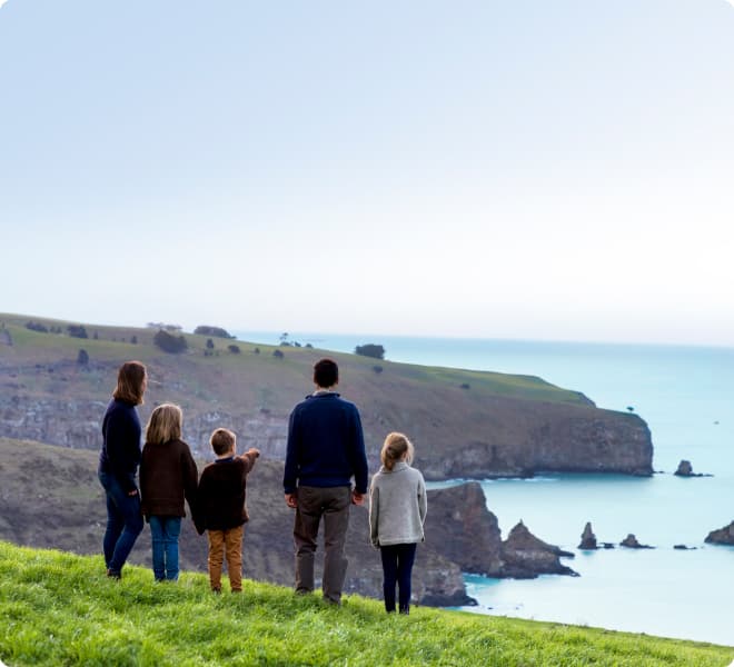 Family on farm looking at the ocean